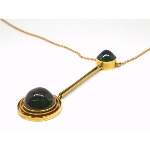 89 - A necklace being a pendant comprising two blue - green cabuchon stones in circular yellow metal sett... 