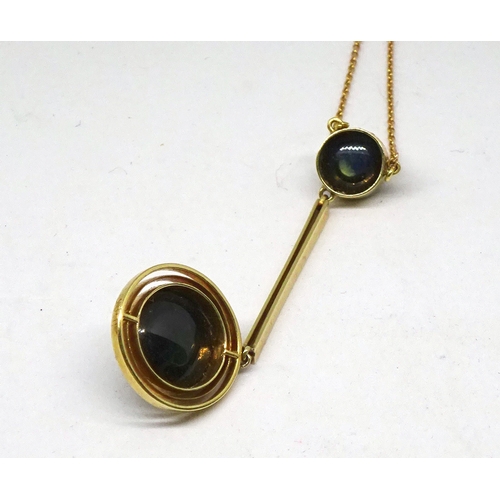 89 - A necklace being a pendant comprising two blue - green cabuchon stones in circular yellow metal sett... 