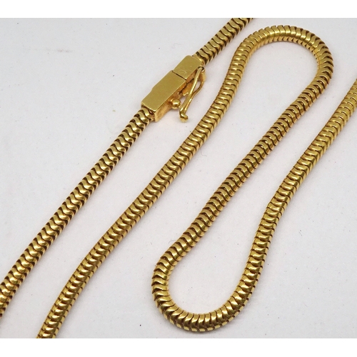 91 - A serpentine necklace, yellow metal marked 18k.  422mm long. (by instruction of the family of Dame F... 