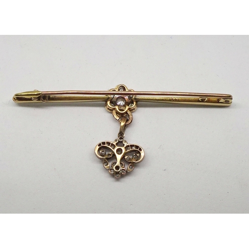 92 - A bar brooch yellow and white metal comprising a central daisy cluster of seven brilliant cut white ... 