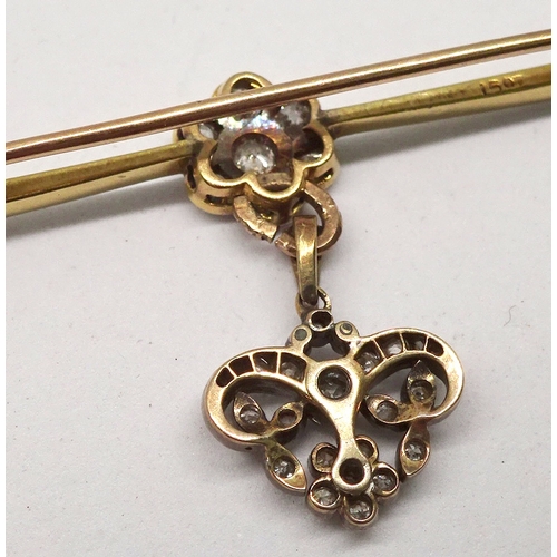 92 - A bar brooch yellow and white metal comprising a central daisy cluster of seven brilliant cut white ... 