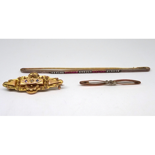94 - A bar brooch, unmarked yellow and white metal set with red and white stones, 122mm long; a stone set... 
