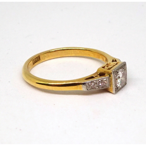 97 - A ring comprising a single brilliant cut white stone set in a square setting with raised, stone set ... 