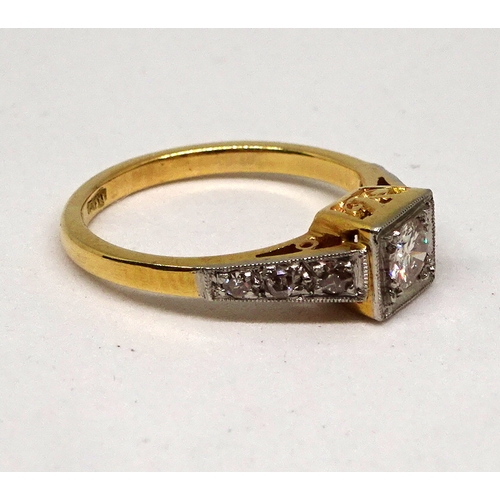 98 - A ring comprising a single brilliant cut white stone set in a square setting with raised, stone set ... 