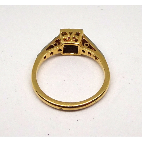 98 - A ring comprising a single brilliant cut white stone set in a square setting with raised, stone set ... 