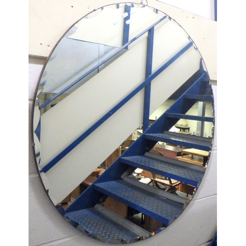 708 - A circular frameless wall mirror