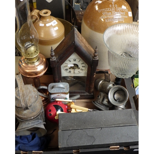 163 - A shelf clock, two stoneware flagons, a railway hand lantern, two cycle lamps, pianola rolls, a jam ... 