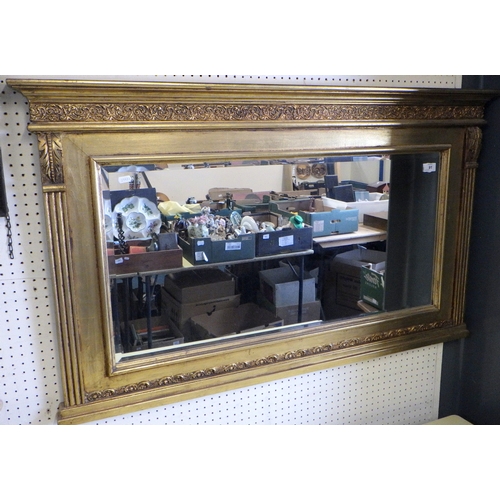 91 - A gilt overmantle bevelled mirror 120 cm 70 cm high.