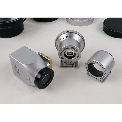 40 - A Leitz Elmar 50mm lens; three various Leitz shoe-mount view finders 21mm / 50mm / 135mm; three Leit... 