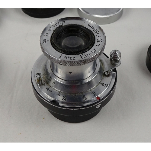 40 - A Leitz Elmar 50mm lens; three various Leitz shoe-mount view finders 21mm / 50mm / 135mm; three Leit... 