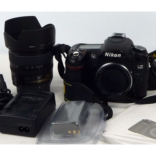 50 - A Nikon D80 DSLR and Nikon DX 18-70mm lens together with batteries, a charger, manual etc