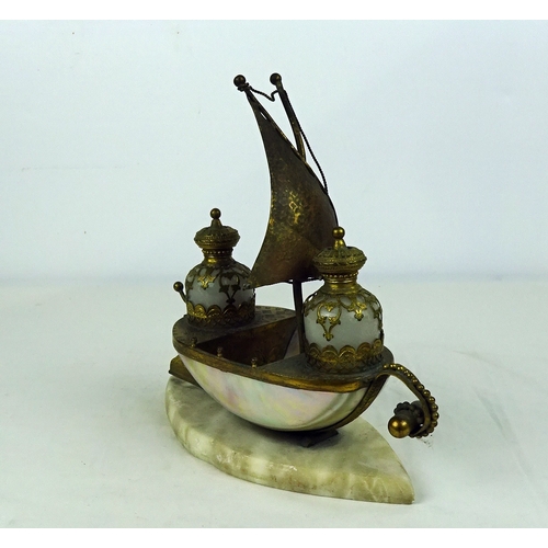 287 - A Gilt metal and shell ship scent bottle holder on a marble base 22cm high.