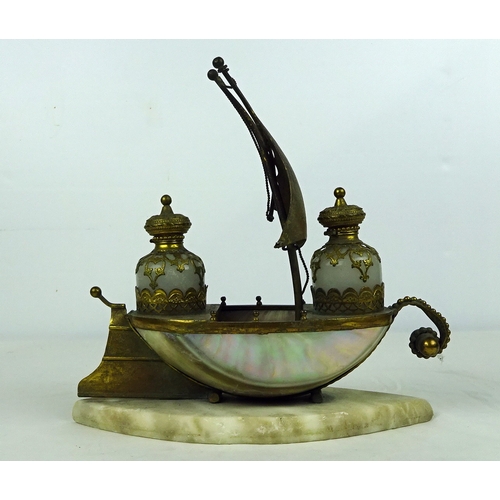 287 - A Gilt metal and shell ship scent bottle holder on a marble base 22cm high.