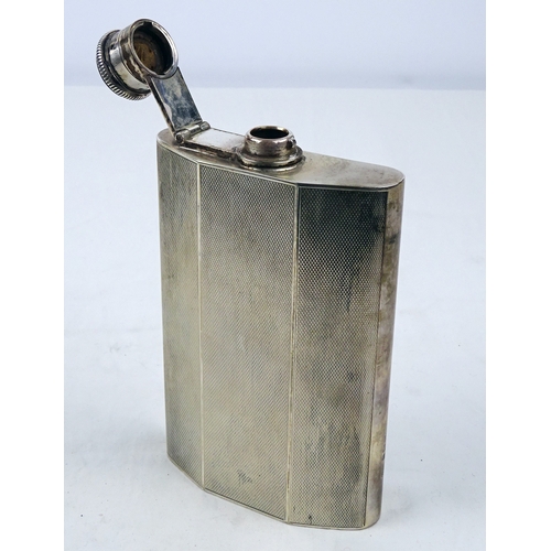 387 - A silver hip flask having engine turned decoration, Birmingham 1946.  135mm tall / 190gr