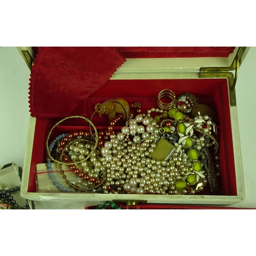 394 - A qty of costume jewellery, a white jewellery case.