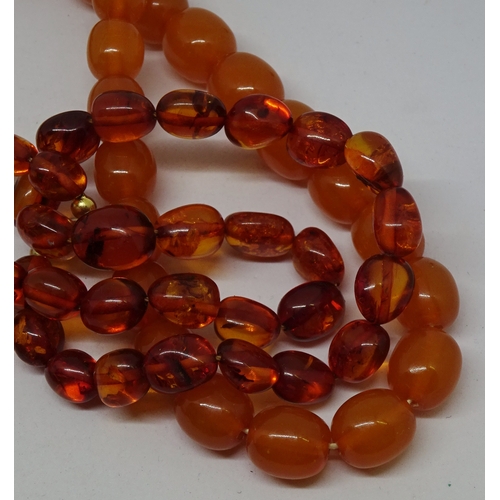 405 - Two necklaces of amber coloured beads.