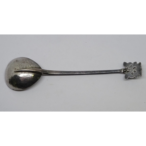 406 - An Arts and Crafts spoon having a planished pear shaped bowl, knotwork engraved stem and lotus motif... 