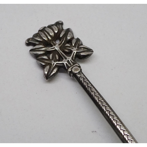 406 - An Arts and Crafts spoon having a planished pear shaped bowl, knotwork engraved stem and lotus motif... 