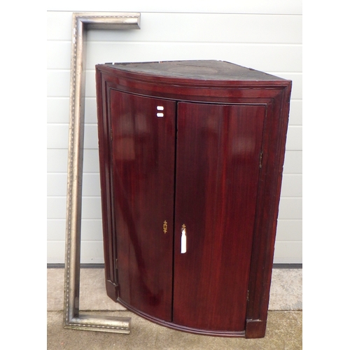 592 - A 19th cen mahogany bow fronted corner cupboard together with a kerb fender, 136cm wide.