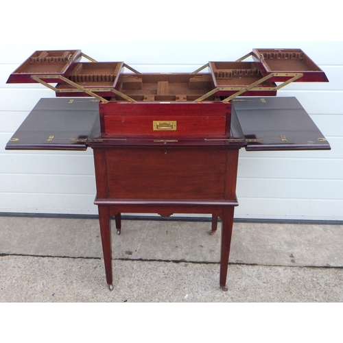 616 - An Edwardian mahogany rising concertina cutlery table, 62cm wide, 79cm tall, with label Eveleigh Bis... 