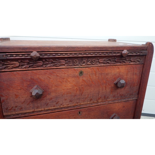 628 - An oak arts and crafts chest of drawers dated 1929 in the manner of Gordon Russell, 72cm wide, 63cm ... 