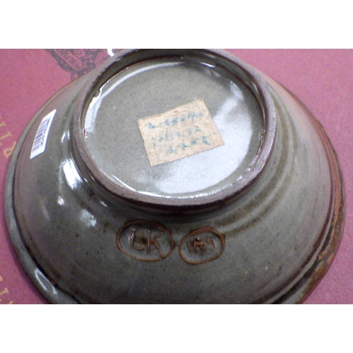 220 - A small studio pottery dish stamped LK 14cm diameter together with a further studio pottery dish (M ... 