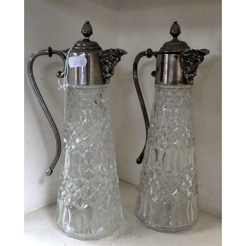 225 - A pair of silver plated claret jugs 29cm tall.