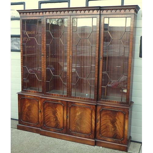 701 - A reproduction mahogany breakfront four door cabinet with glass shelves on a lower cupboard base 204... 