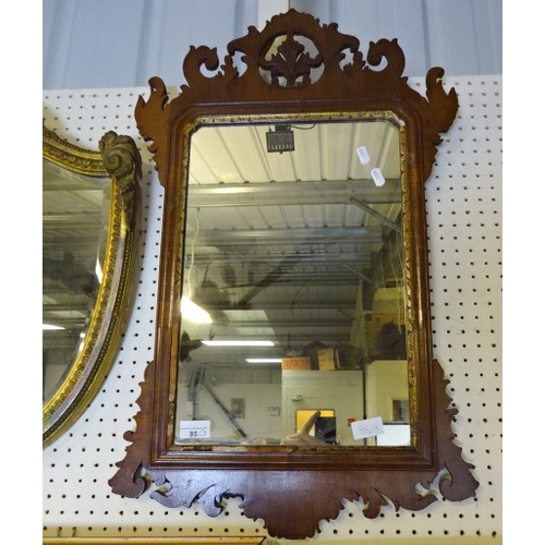 85 - A gilt shield bevelled mirror 53cm long af repairs together with a mahogany framed and a small mirro... 