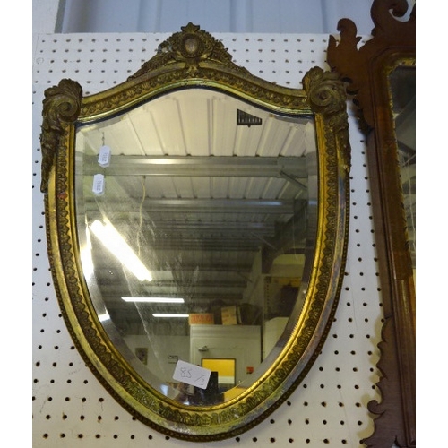 85 - A gilt shield bevelled mirror 53cm long af repairs together with a mahogany framed and a small mirro... 