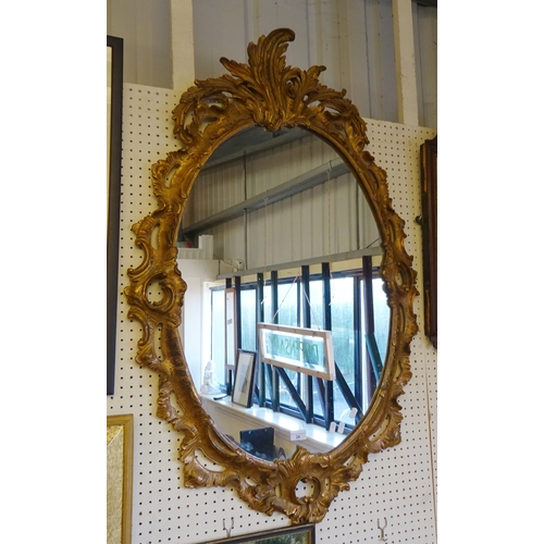 28 - A fretwork framed wall mirror, frame a/f; an oval gilt framed wall mirror (2)