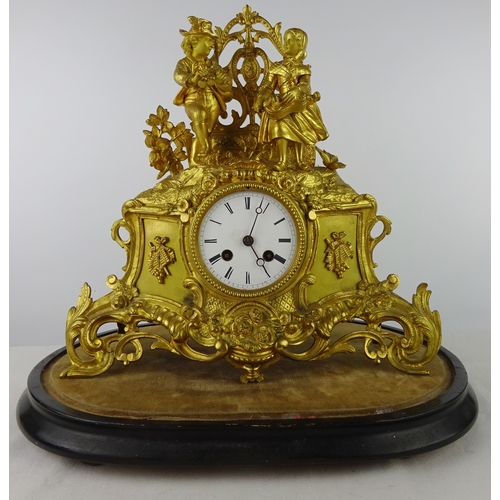 3 - A continental mantel clock in a gilt base metal figural case, approximately 35cm tall presented on a... 