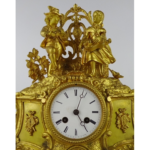 3 - A continental mantel clock in a gilt base metal figural case, approximately 35cm tall presented on a... 