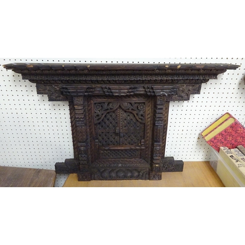 81 - A carved Balinese frame 77 x 47 cm together with a large mirror86cm x 58cm (2).