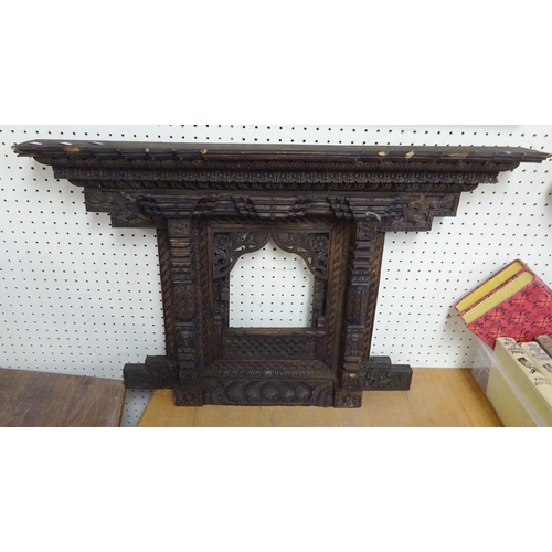 81 - A carved Balinese frame 77 x 47 cm together with a large mirror86cm x 58cm (2).