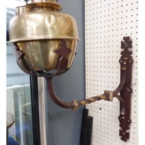 292 - A pair of brass oil lamps on wrought iron wall sconces