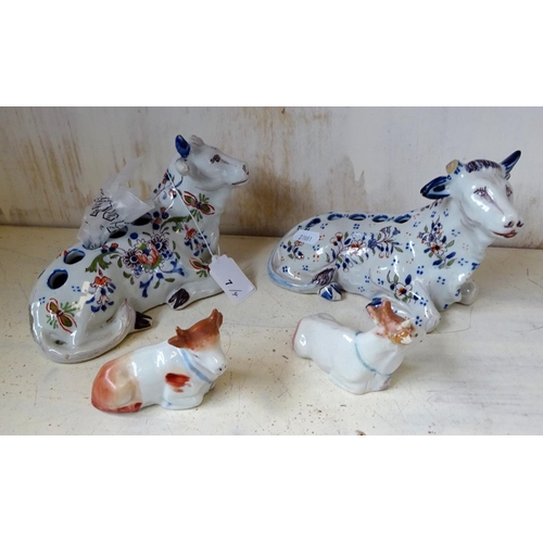 7 - Two Quimper Faience cow vase's 9cm tall 18cm wide af one missing horn, one loose horn, together with... 