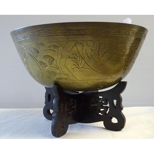 89 - A small Chinese bowl on stand together with cast metal figure group, three hardwood stands, an ornam... 