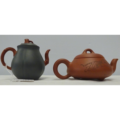 103 - A small green Chinese tea pot decorated with tree branches stamped to the base and the handle 10cm h... 