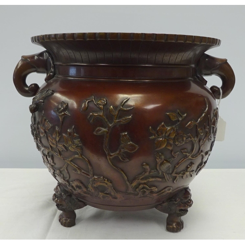 117 - A large bronze Japanese jardiniere, decorated with tree's and bird relief 40cm wide 30cm high.