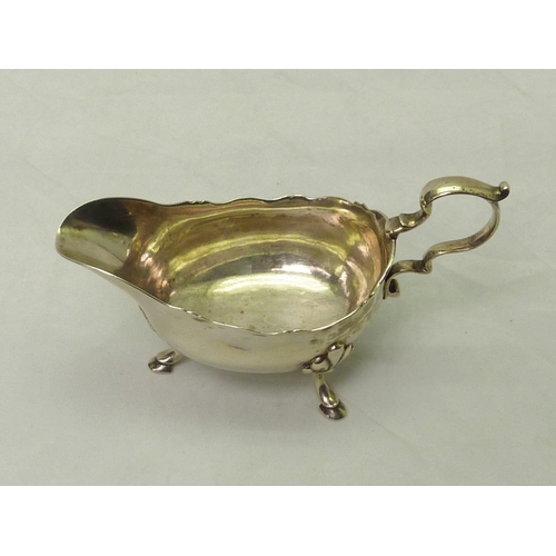 301 - A George III silver sauce boat engraved with a bird & laurel leaf armorial, partial Dublin hallmark.... 
