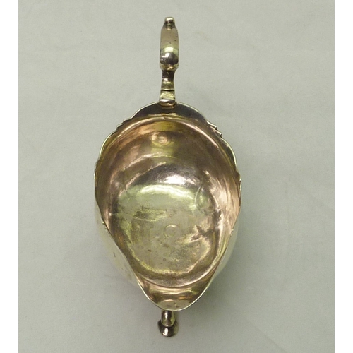 301 - A George III silver sauce boat engraved with a bird & laurel leaf armorial, partial Dublin hallmark.... 