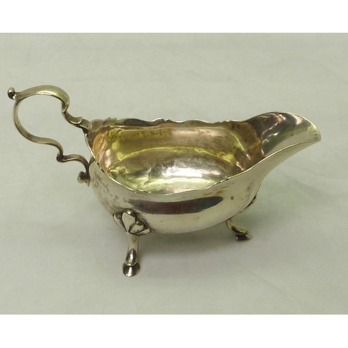301 - A George III silver sauce boat engraved with a bird & laurel leaf armorial, partial Dublin hallmark.... 