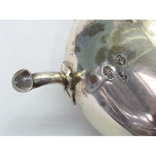 301 - A George III silver sauce boat engraved with a bird & laurel leaf armorial, partial Dublin hallmark.... 