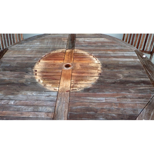 555 - A large circular teak garden table with four chairs (a/f)  loose, 180cm across