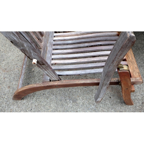 555 - A large circular teak garden table with four chairs (a/f)  loose, 180cm across