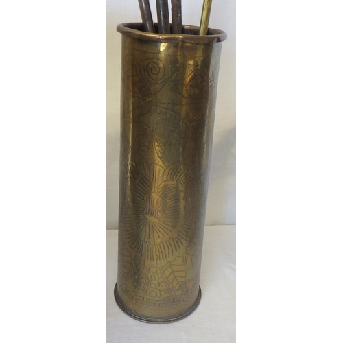 32 - A brass log bucket on three claw feet; a trench art shell case; a companion set etc.