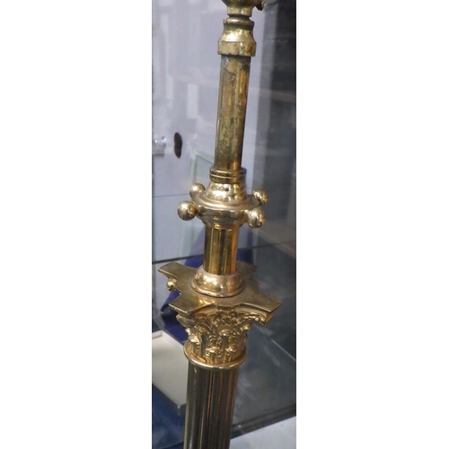 94 - A brass Corinthian Column telescopic lamp standard on four claw feet