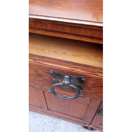 601 - An Art Nouveau oak  sideboard 155cm wide, holes to the top.