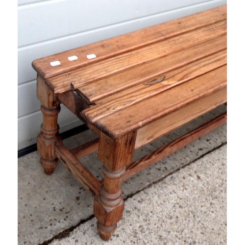 604 - A Victorian pine long railway platform bench, missing back rest 152cm long